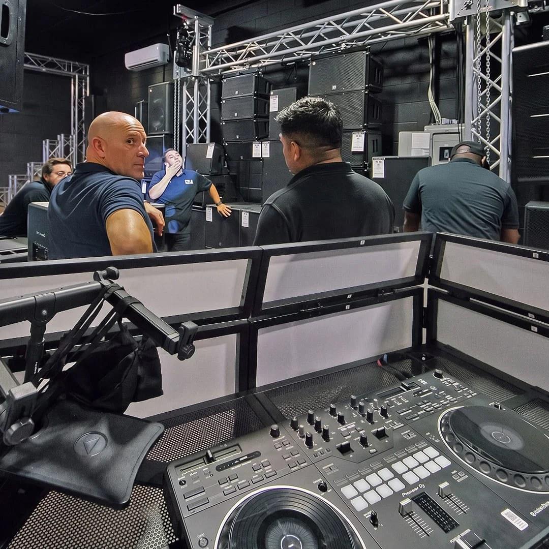 Customers trying DJ controllers and speakers inside the Musically Yours store